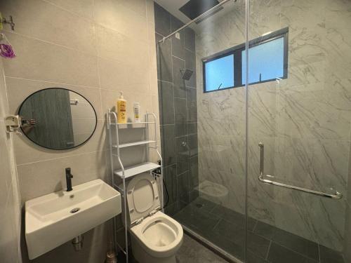 a bathroom with a toilet and a sink and a shower at Zhara Homestay in Ipoh