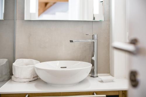 a white sink on a counter in a bathroom at Seehotel Brandauer's Villen in Strobl