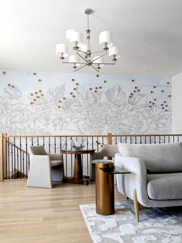 a living room with a couch and a chandelier at Maison à Deux Mains in Ay
