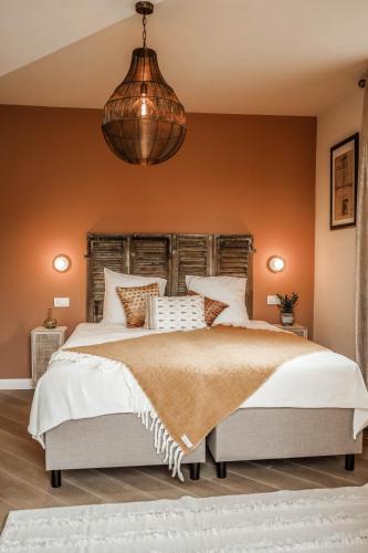 a bedroom with a large bed with a wooden headboard at Residenza Villa Genua in Bordighera