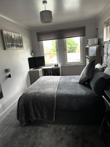 a bedroom with a large bed and a window at Burnside in Oban