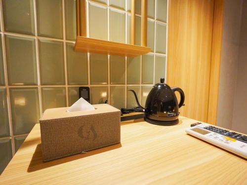 a box on top of a table with a tea kettle at The GALA Hotel Umeda in Osaka