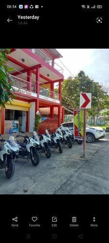 a row of motorcycles parked in front of a building at Talisay Inn in Anda