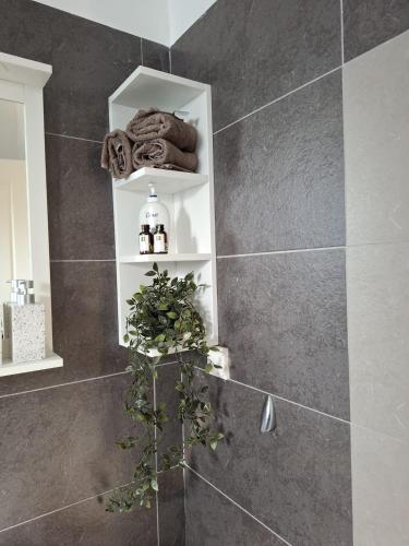 a bathroom with a shower with a plant in it at Villa Lawton - Magnificent sea & mountain views! in Epáno Kefalás