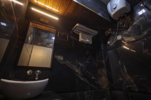 a bathroom with a sink and a mirror at Narayana Homes in Mathura