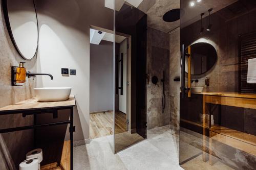 a bathroom with a sink and a shower at Luxury Szklarska Apartments in Szklarska Poręba