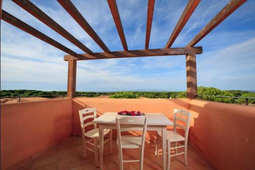 a table and chairs on a balcony with a view at Gallura style Res Baia Del Mirti B4 1BedAp sleeps4 in Vignola Mare