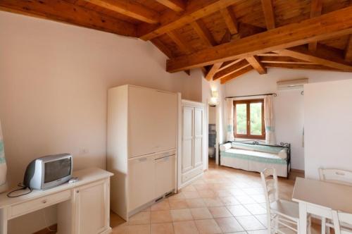 a living room with a tv and a desk with a tv at Gallura style Res Baia Del Mirti B4 1BedAp sleeps4 in Vignola Mare