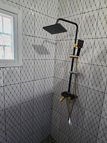 a room with a wall with a baseball bat at Kaira kunda guesthouse in Nimsat