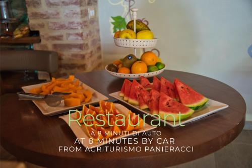 a table topped with two plates of fruit and vegetables at Agriturismo Panieracci in Villamagna
