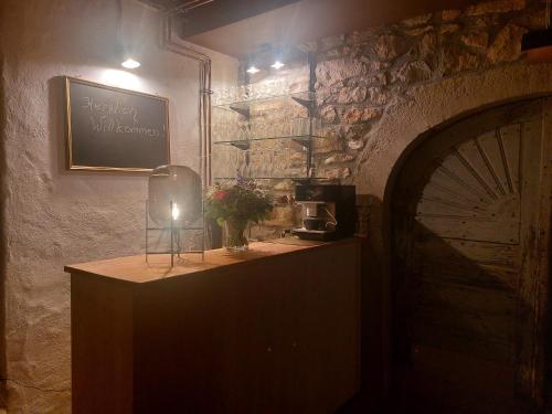a room with a table with a sign on the wall at Kulturvogtei Freiburg-Tiengen in Freiburg im Breisgau