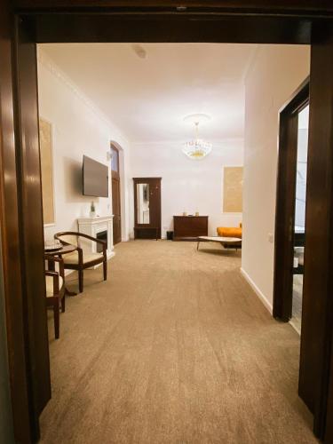 a large living room with a table and a couch at La Maison de Caroline in Alba Iulia