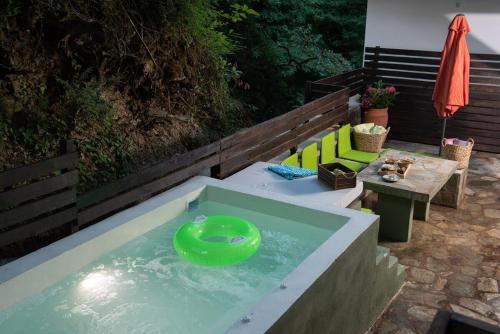 a pool with a green frisbee in the water at Dandy Villas Tsagkarada-Sweet Green Apple-Mini Pool in Tsagarada