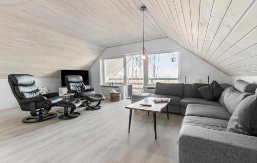 a living room with a couch and two chairs at 4 Bedroom Amazing Home In Ørsted in Ørsted
