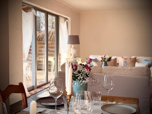 a living room with a table with wine glasses at Neu! ULENHUUS Mecklenburgische Schweiz Laage Güstrow Rostock Port Bed and Breakfast - Pension -Ferienhaus - Familienurlaube bis 10 Personen in Kuhs