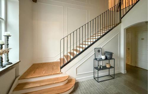 a staircase in a home with wooden floors at Nice Home In Ekeby With Wifi in Ekeby