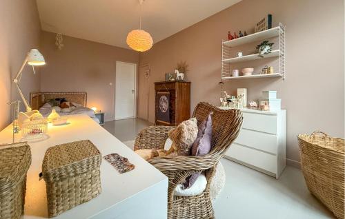 a living room with a table and wicker chairs at Nice Home In Ekeby With Wifi in Ekeby