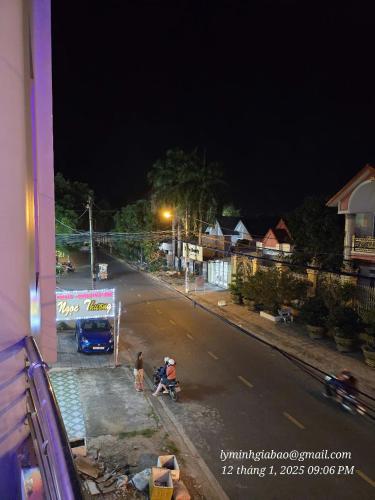 a couple of people on a street at night at Khách Sạn Minh Nhựt in Rach Gia