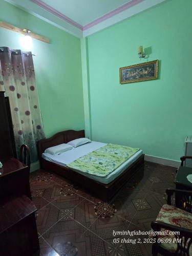 a bedroom with a bed in a room at Khách Sạn Minh Nhựt in Rach Gia