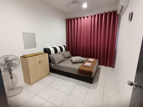 a bedroom with a bed and a red curtain at Naanee Homestay near Putrajaya Cyberjaya - musleem only in Kampung Dengkil