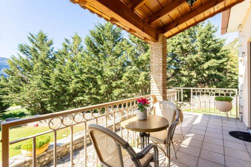 a patio with a table and chairs on a balcony at Pleiades Studios All Season Gems - Korinthos Stone Retreats in Kalianoi