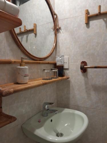 a bathroom with a sink and a mirror at Tâm Homestay in Hue