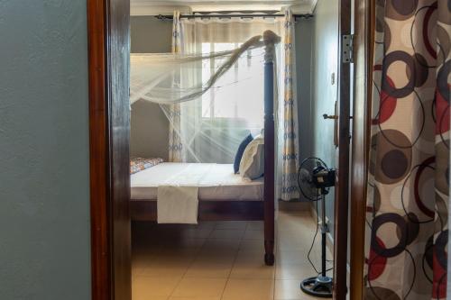 a small bedroom with a bunk bed with a window at Simba The lion Apartment Mawanda Road in Kampala