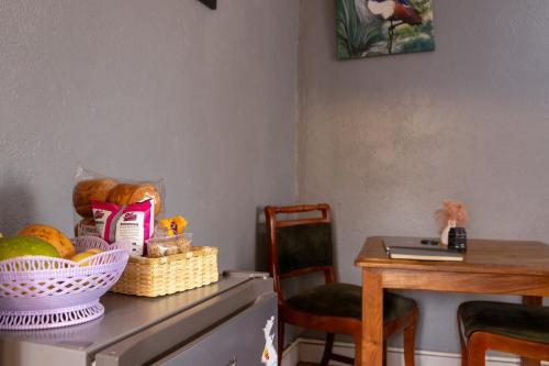 a table with a basket of food on top of a refrigerator at Simba The lion Apartment Mawanda Road in Kampala