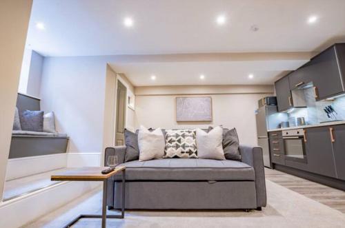 a living room with a couch in a kitchen at WhiskAwayHomes - Shaw Street - Apartment 2 in Worcester