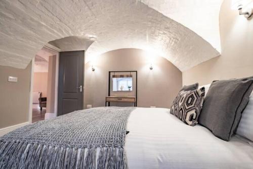 a bedroom with a large white bed with black pillows at WhiskAwayHomes - Shaw Street - Apartment 2 in Worcester