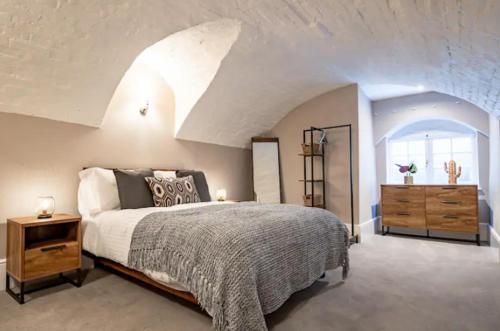 a bedroom with a king sized bed and a dresser at WhiskAwayHomes - Shaw Street - Apartment 2 in Worcester