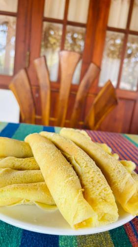 a white plate with two bananas on a table at Mount Side Hiriketiya in Hiriketiya