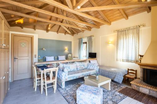 a living room with a couch and a table at Pleiades Studios All Season Gems - Korinthos Stone Retreats in Kalianoi