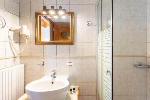 a bathroom with a sink and a mirror and a shower at Pleiades Studios All Season Gems - Korinthos Stone Retreats in Kalianoi