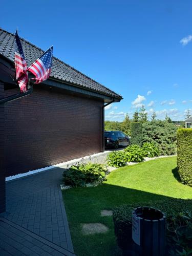 an american flag on the side of a house at Premium Residence SPA & Garden in Glińcz