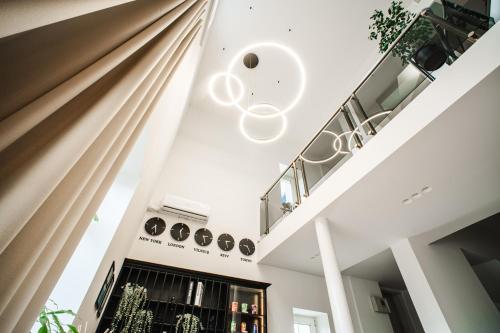 a staircase in a house with white ceilings at Hotel Tomas in Šiauliai