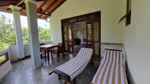 a living room with two chairs and a table at Villa Arana Bentota in Bentota