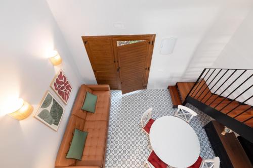 an overhead view of a living room with a table and stairs at The Little Village Apartments in Valencia