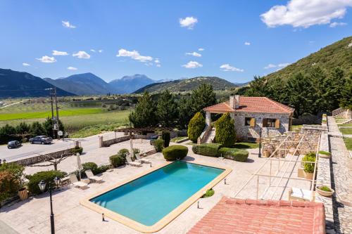 a villa with a swimming pool and mountains at Pleiades Studios All Season Gems - Korinthos Stone Retreats in Kalianoi