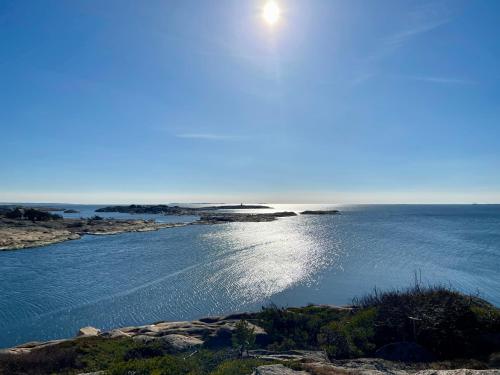 an island in the water with the sun in the sky at Hankø Hotell & Spa in Gressvik