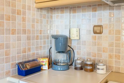 a blender sitting on a counter in a kitchen at Pleiades Studios All Season Gems - Korinthos Stone Retreats in Kalianoi