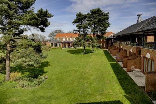 an aerial view of a yard next to a building at Knights Hill Hotel & Spa in Kings Lynn