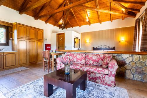 a living room with a couch and a table at Pleiades Studios All Season Gems - Korinthos Stone Retreats in Kalianoi