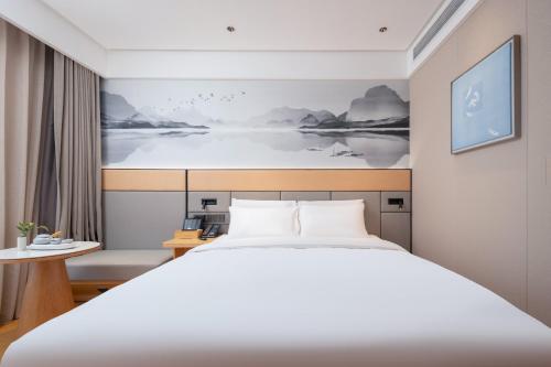 Postel nebo postele na pokoji v ubytování Bo Ting Hotel泊庭酒店