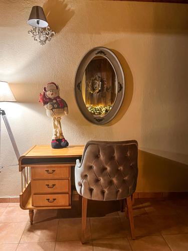 a desk with a chair and a mirror on a wall at Dandy Villas Tsagkarada-Sweet Green Apple-Mini Pool in Tsagarada