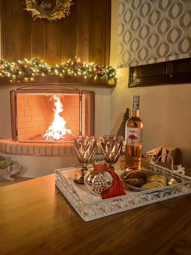 a tray with a bottle of wine and glasses on a table at Dandy Villas Tsagkarada-Sweet Green Apple-Mini Pool in Tsagarada