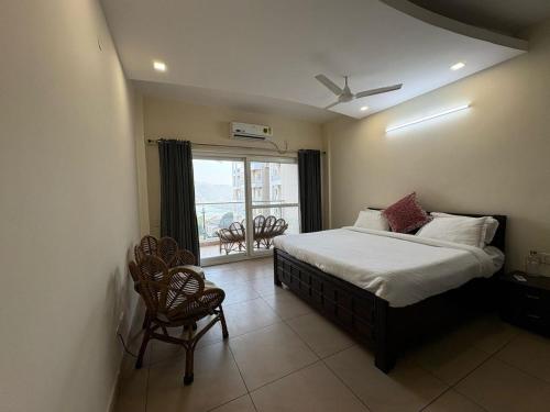 a bedroom with a bed and a window with a view at Golden Healing Journeys Homestay in Rishīkesh