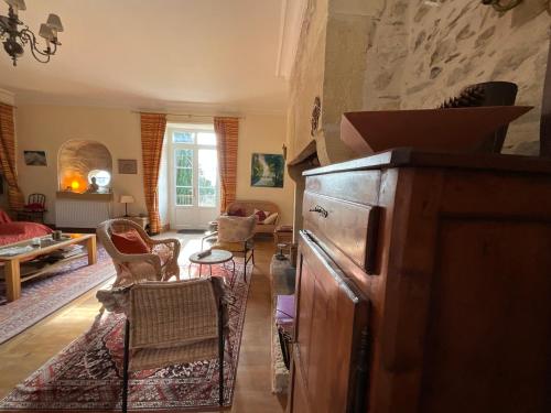 a living room with a couch and a table at Maison de la Source in Génis