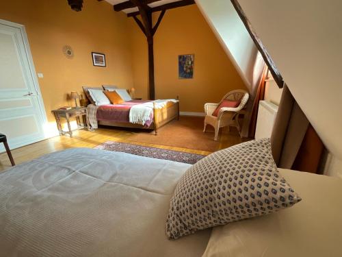a bedroom with a bed and a room with a bed at Maison de la Source in Génis