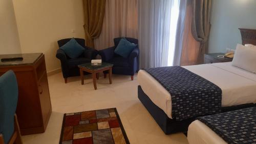 Postel nebo postele na pokoji v ubytování Boudl Grand Pyramids